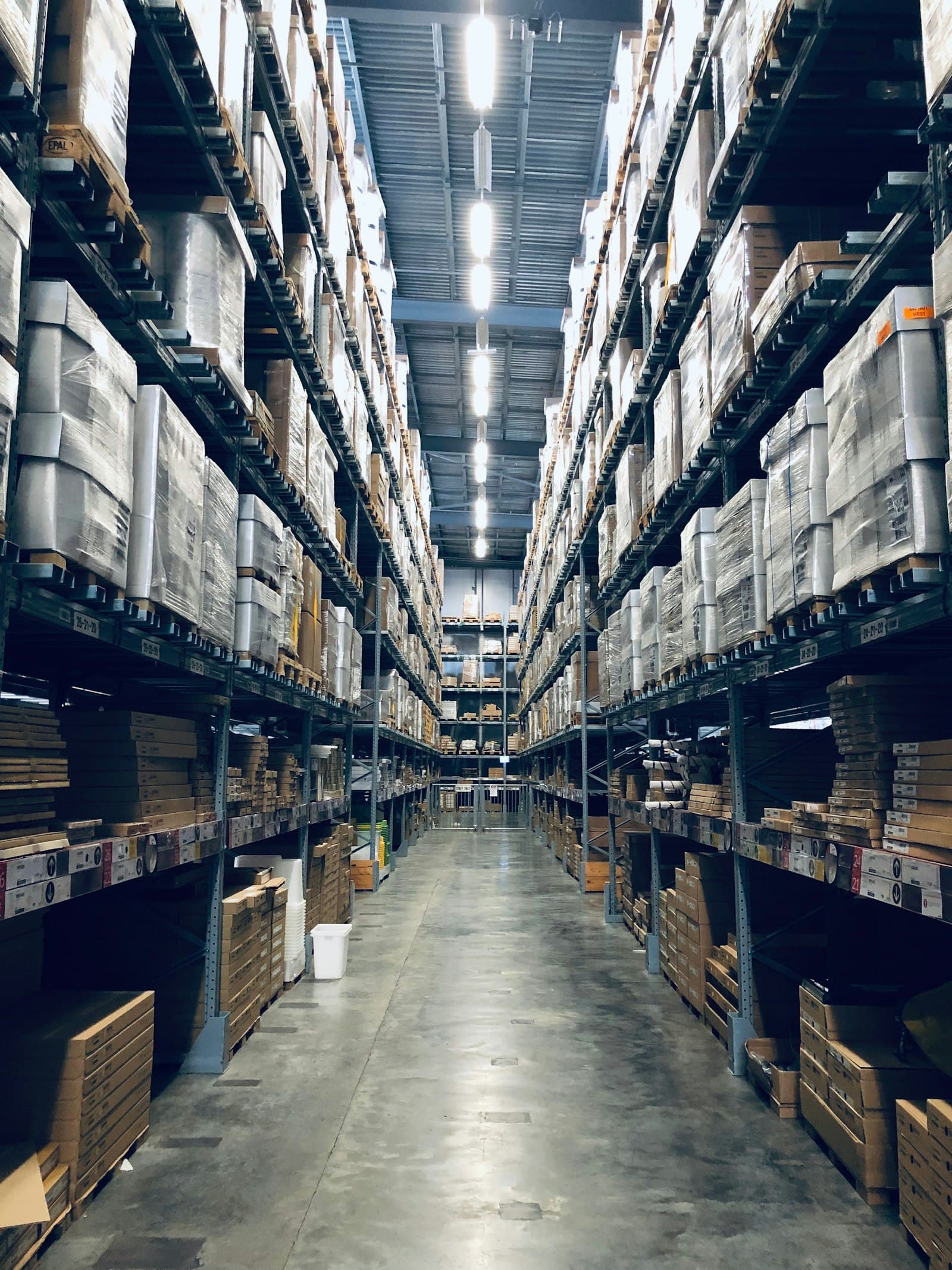 A racked warehouse aisle with labelled stock